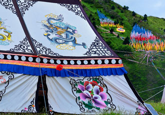 Tibetan Tent with Prayer Flags on Distant Hill